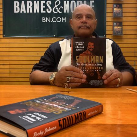 Wanda Bowles' late father, Rocky Johnson, took a picture as he held his book at a meet and greet.